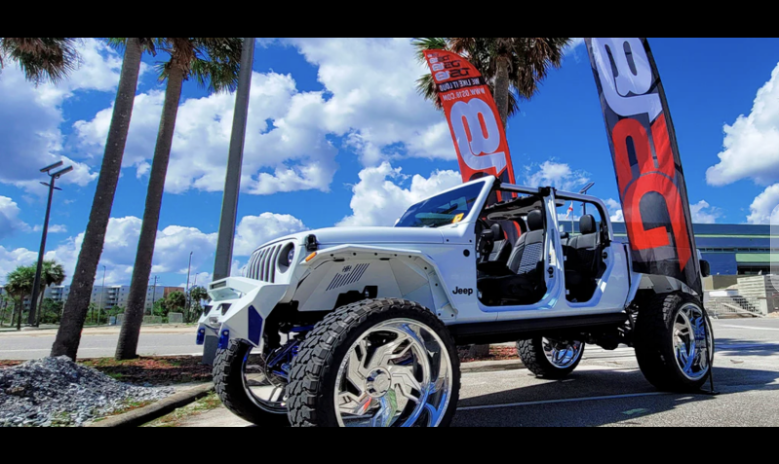 white car with ds18 banners in background